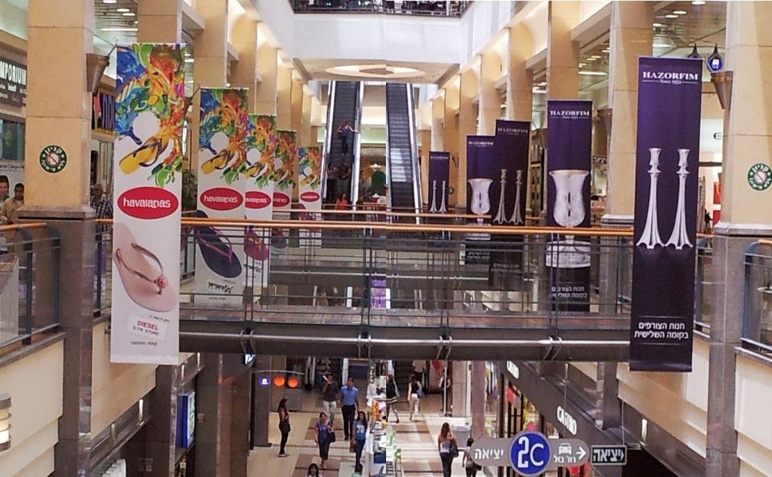 Double-sided blockout banners hanging indoors at a mall.