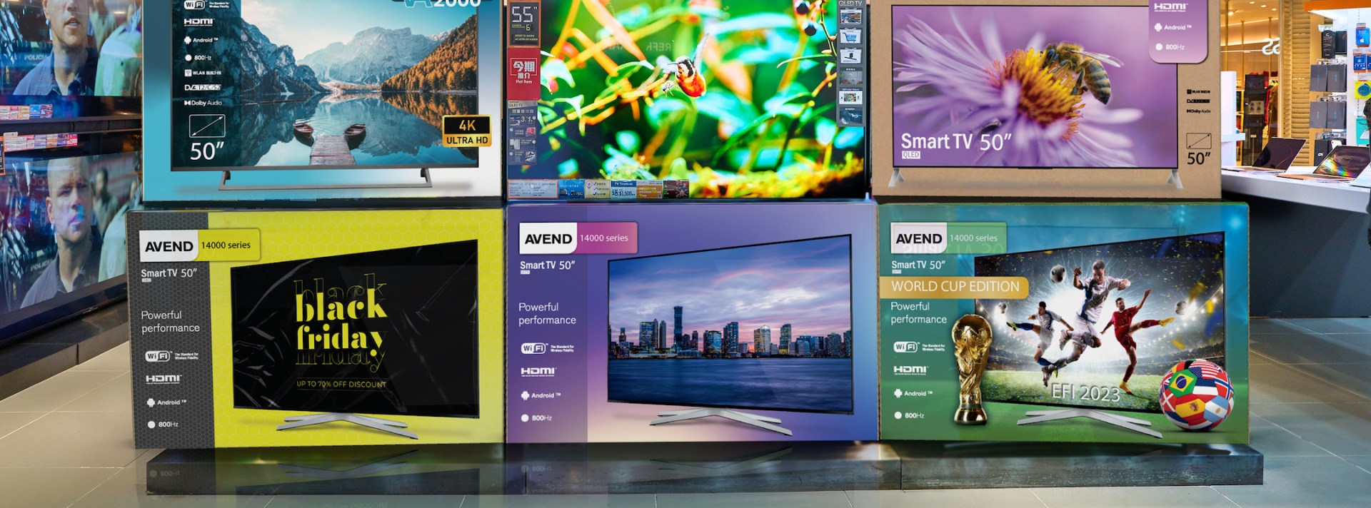 Display of colorfully printed television boxes in a retail store.