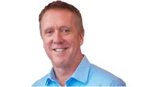 Chuck Novak's a smiling business professional in a blue shirt