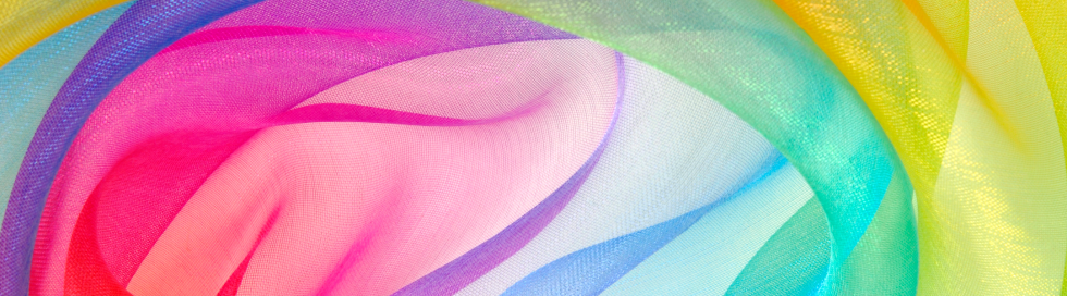 Abstract image of flowing multicolored fabric with smooth gradients and visible textile texture.